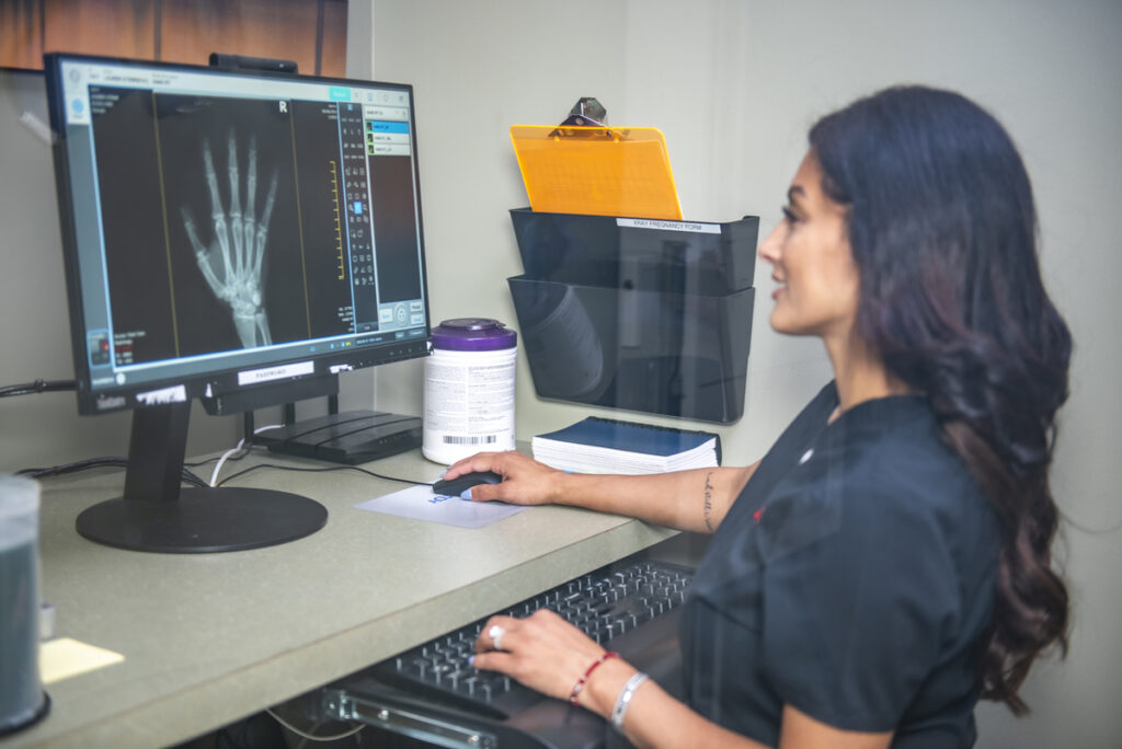 Access Total Care staff looking over xrays from a workers compensation patient case