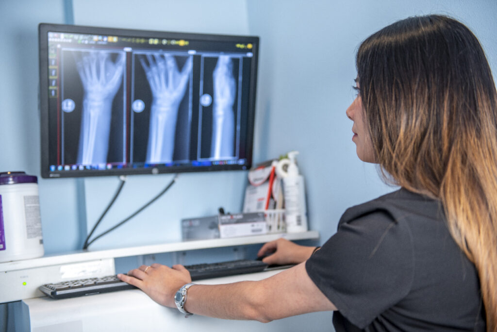 a woman offering specialized urgent care looking over xrays