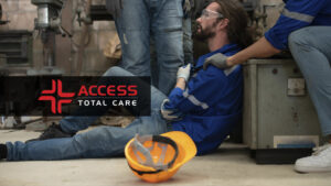 a man on the floor of a factorty in pain suffering from workplace injuries