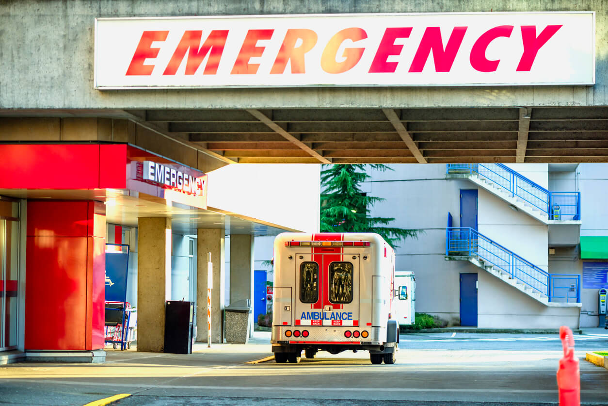 ambulance car parked near the emergency entrance to the hospital