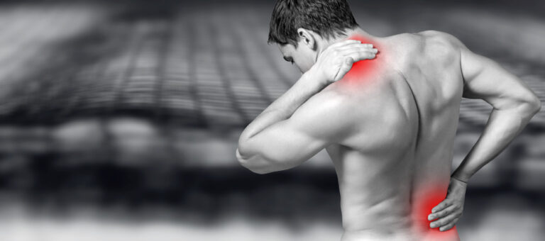Back view of shirtless man touching his aching back and neck from muscle strain