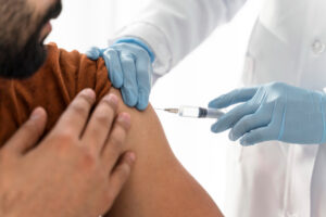 close up of a man getting a flu shot at an urgent care facility