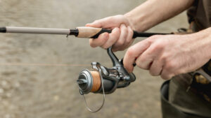 closeup of hands fishing and reeling in the net, fishing injuries