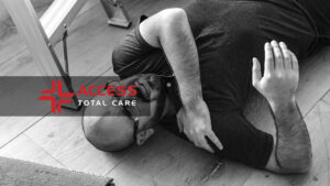 a bald middle aged man with glasses lying on the ground in pain from a slip and fall accident